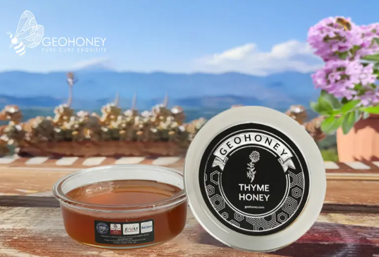 A Jar of thyme honey from geohoney is placed on a table